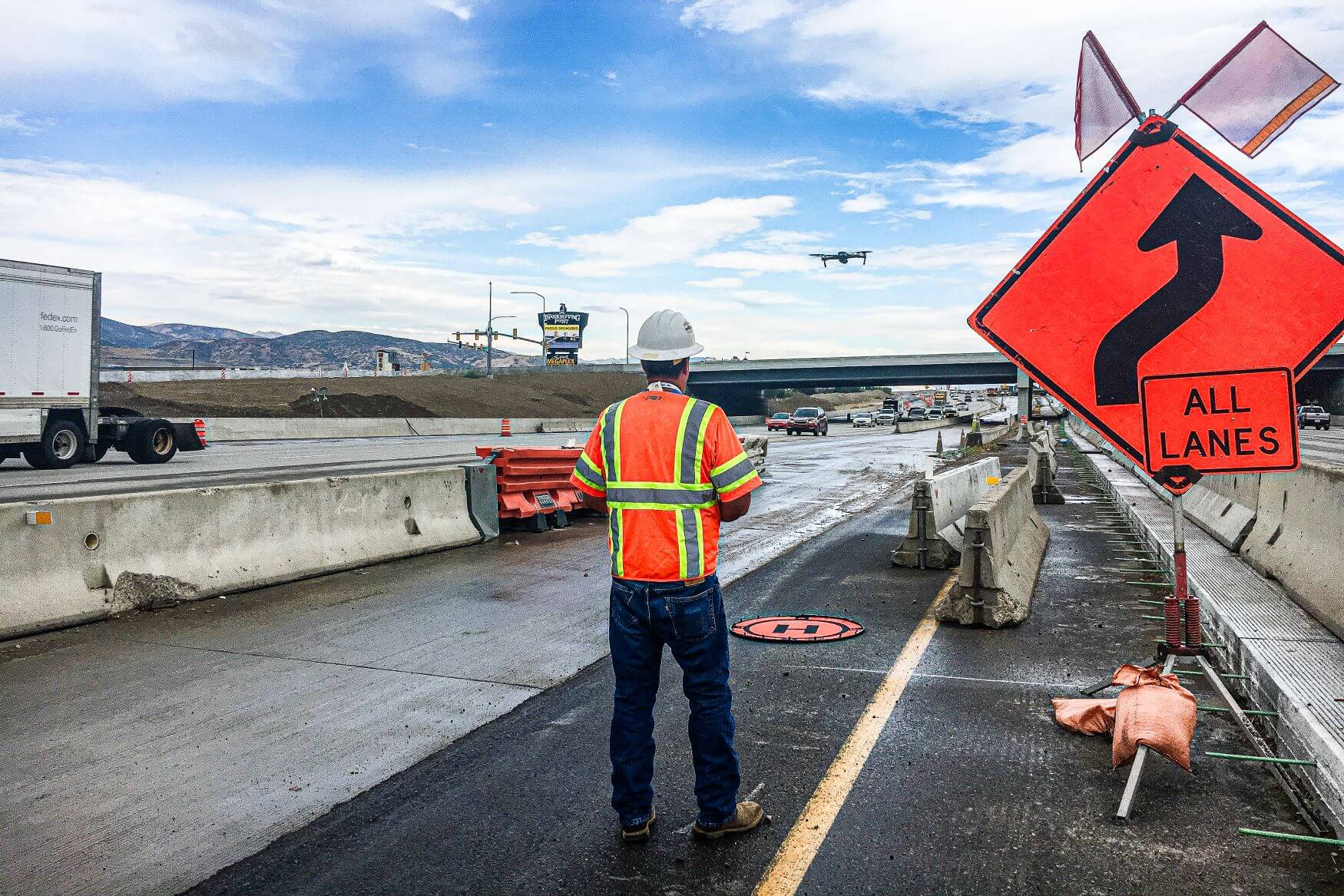 UAS operator flying drone over highway