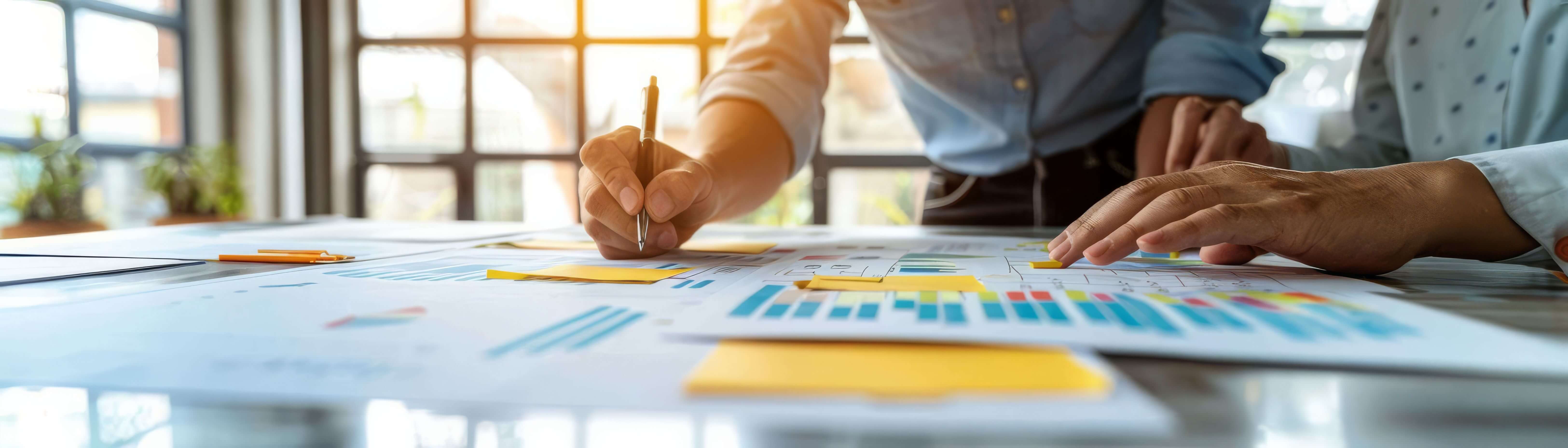 Two people examining graphs