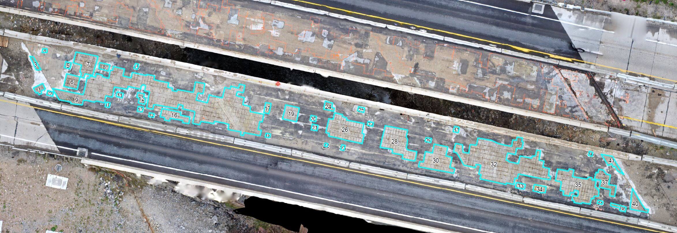 Aerial view of two parallel, elevated concrete roadways with significant surface wear