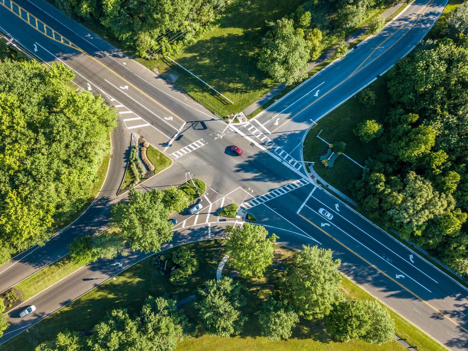 Aerial view of an intersection with crosswalks on a sunny day