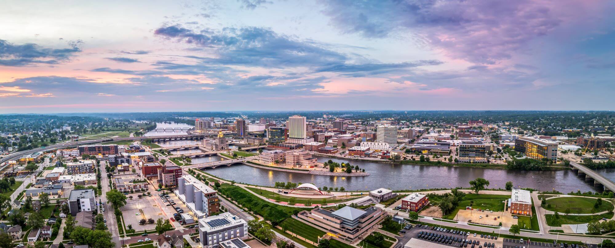 Panoramic aerial view of Cedar Rapids, Iowa under a pink and blue sky
